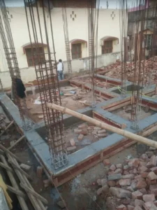 Column reinforcement and plinth beam shuttering at the foundation stage of a house in Bokar