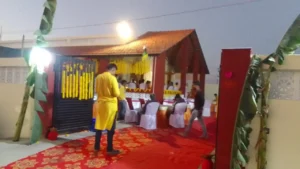 Farmhouse veranda decorated with marigold garlands and a red carpet for a family celebration near Ranchi