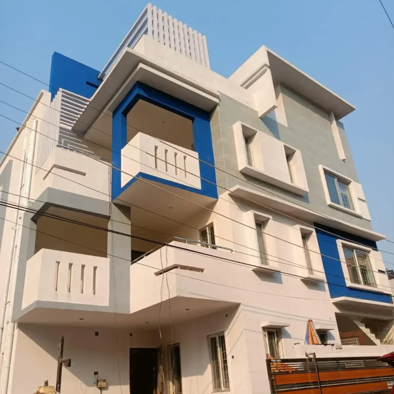1750 sq ft house construction in Bokaro: white home with grey and blue highlights, tile cladding and MS pergola