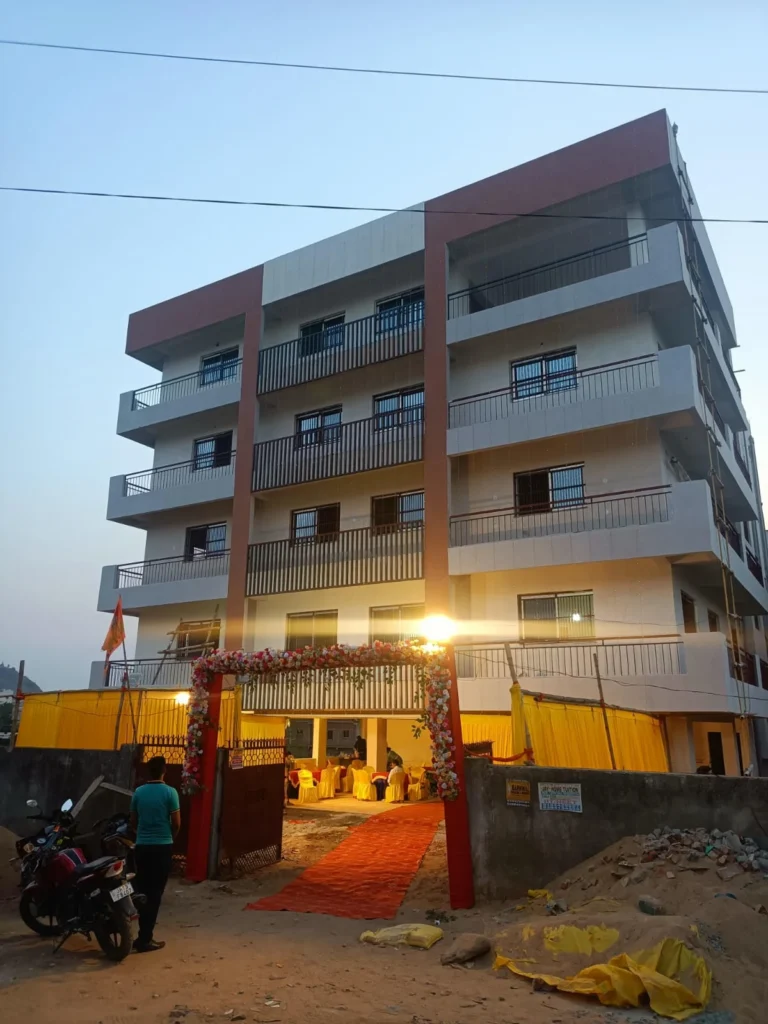 Institutional building construction in Ranchi: completed head office with brown vertical bands and MS balcony railings
